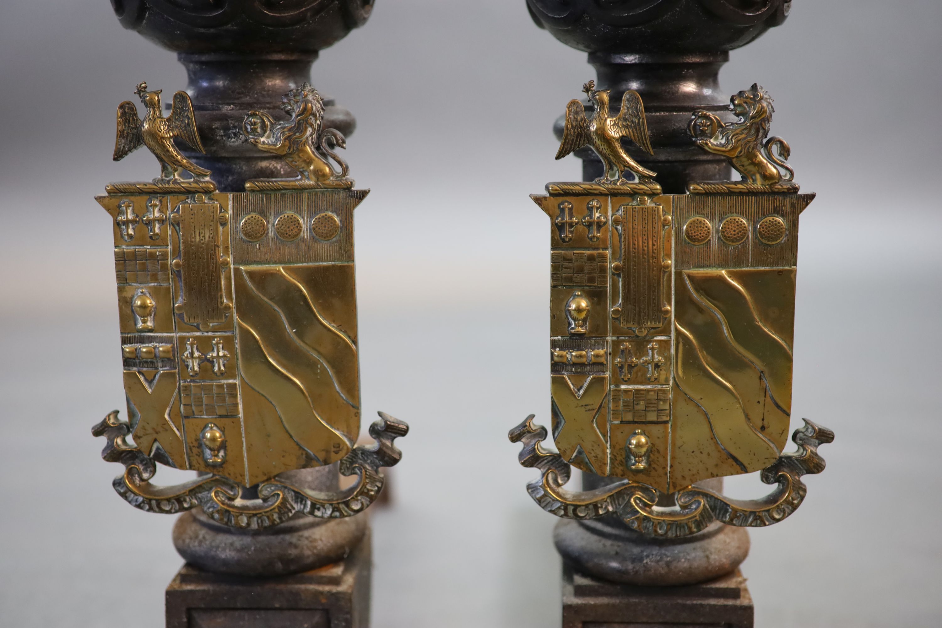 A substantial pair of 19th century heraldic cast iron fire dogs, 55cm deep, 81cm high